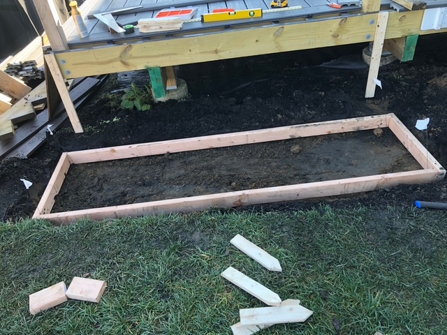 Wood form built for a concrete pad under a backyard deck